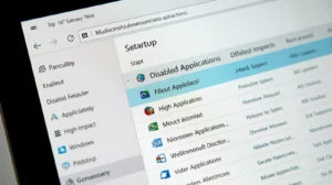 Windows 11 Task Manager open on Startup tab showing enabled and disabled apps, some apps marked high impact, clean desktop environment, realistic interface, sharp text clarity, modern Windows 11 UI, close-up screen capture style, 16:9 ratio, minimal background distraction